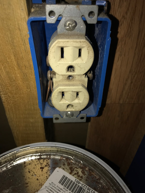 Electrical receptacle/outlet without a cover and wires exposed observed by Dairyland Home Inpsection.